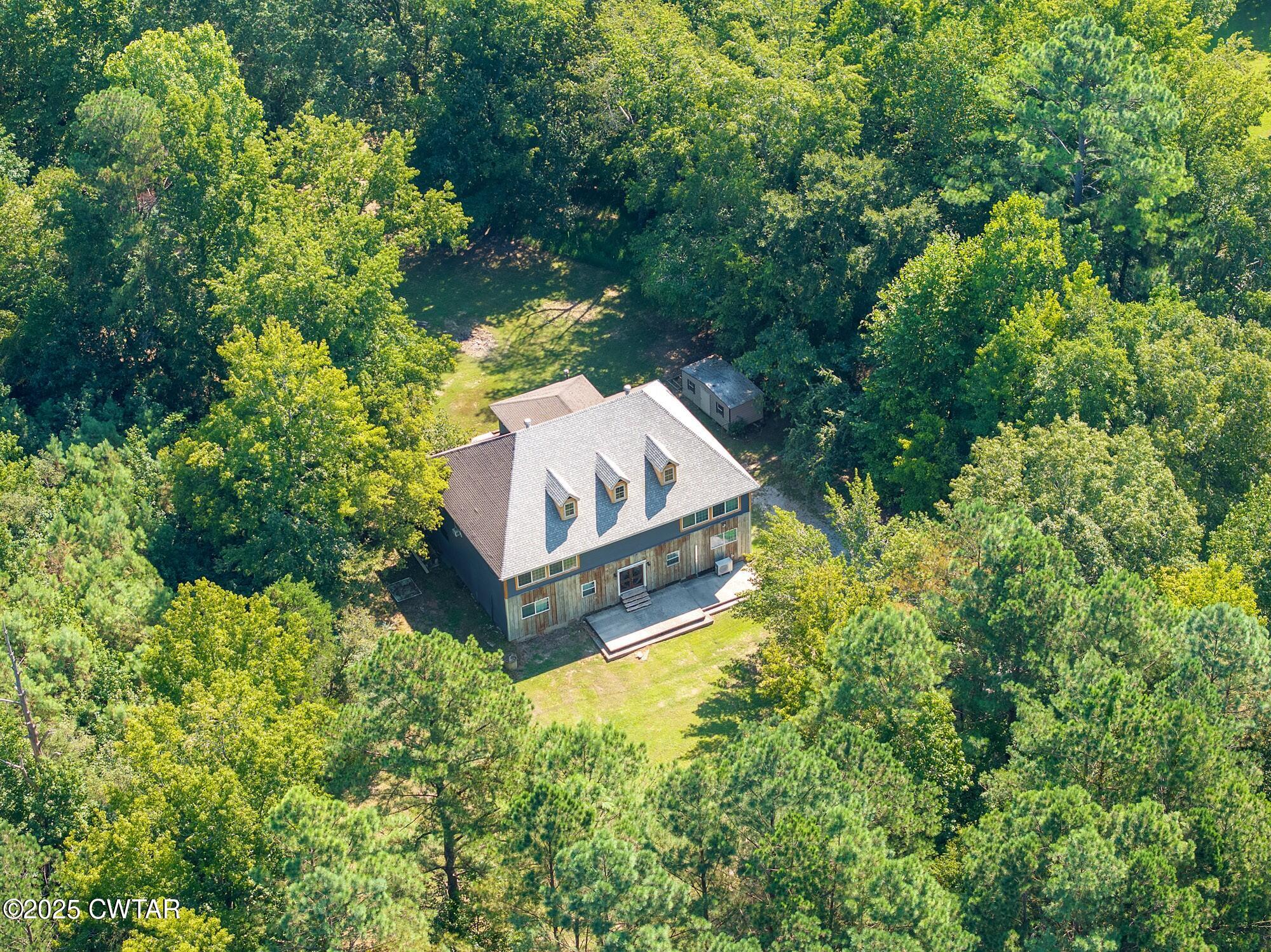 1035 Beacon Road Parsons, TN 38363 - Photo 4 of 70 an aerial view of a house with a yard and large trees