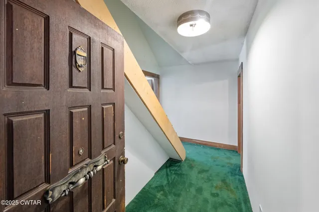 an aerial view of residential house with outdoor space and trees all around