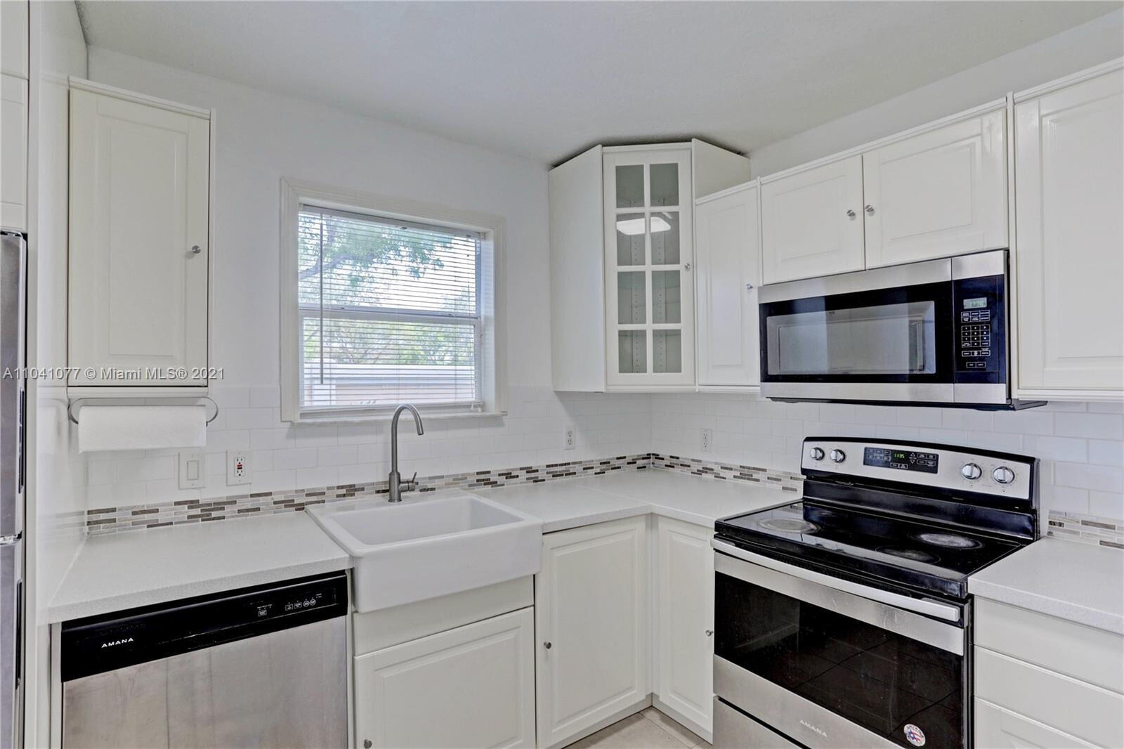 a kitchen with a sink stove and microwave