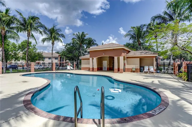 a view of a house with swimming pool and sitting area