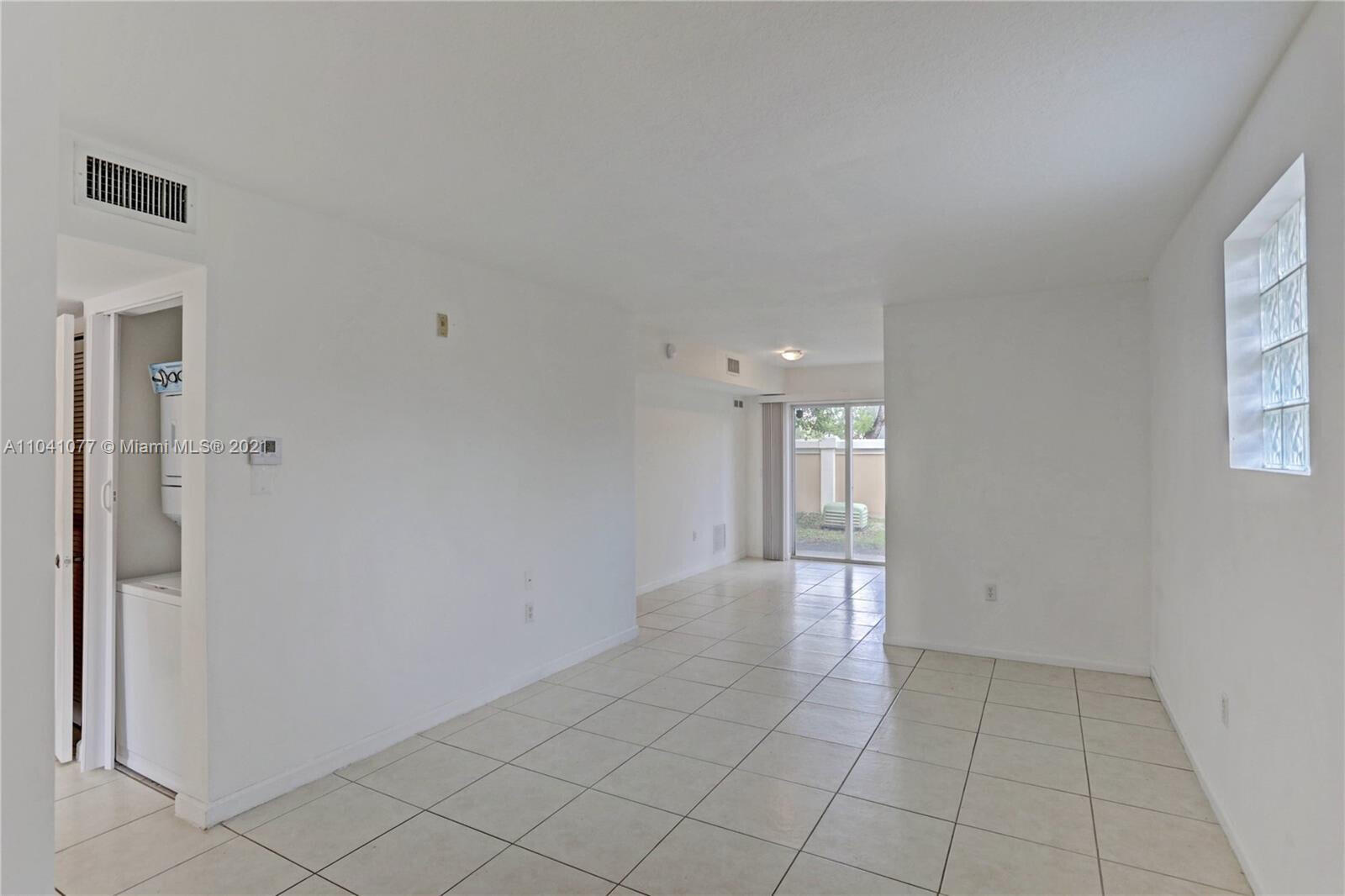 3810 North Jog Road, Unit 106 West Palm Beach, FL 33411 - Photo 6 of 13 a view of an empty room and window