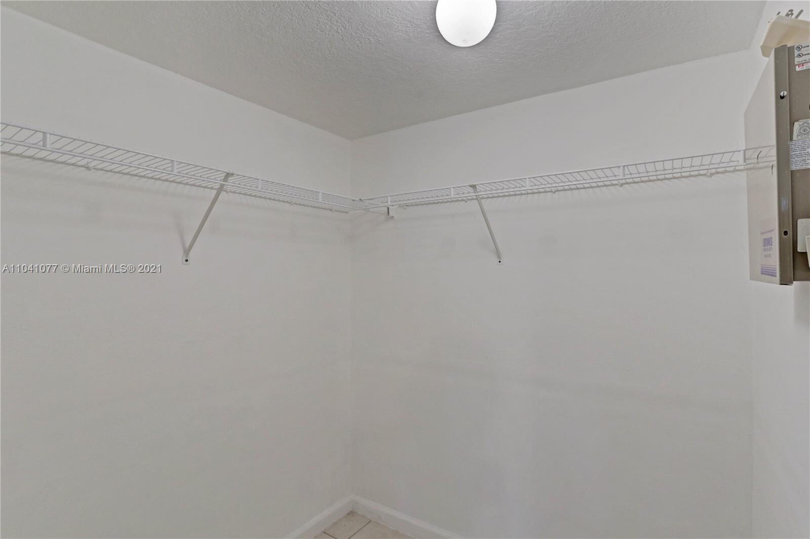 3810 North Jog Road, Unit 106 West Palm Beach, FL 33411 - Photo 7 of 13 a view of a room with racks on the wall