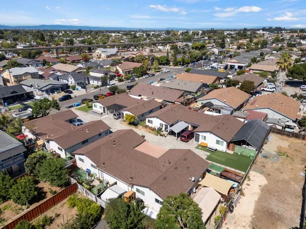 an aerial view of a houses with city view
