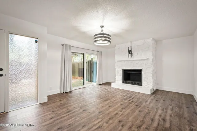 a view of a livingroom with a fireplace cabinet and a rug