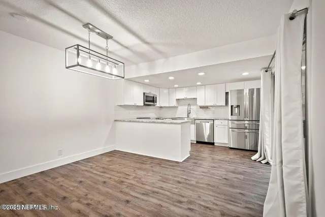 a view of kitchen with wooden floor