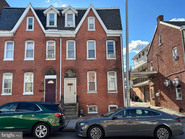 a front view of a house with parking space