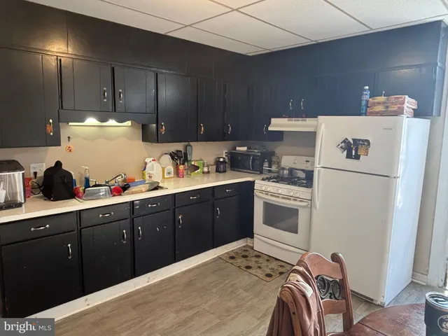 a kitchen with a cabinets and white appliances