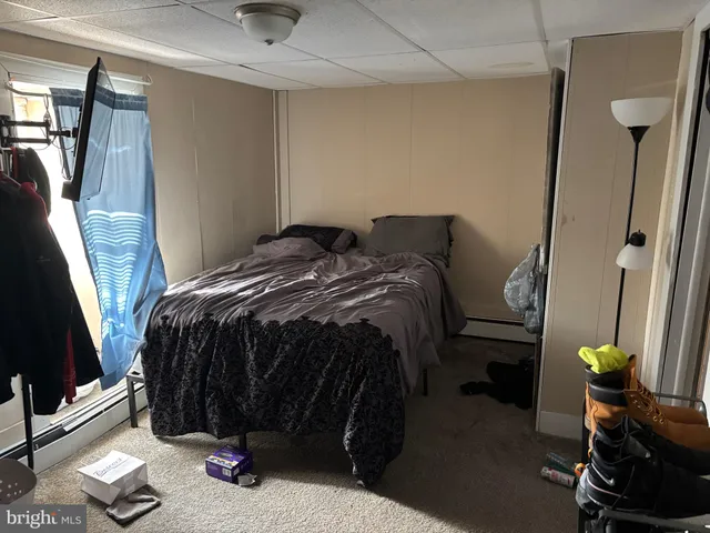 a bed room with two bed and a chair