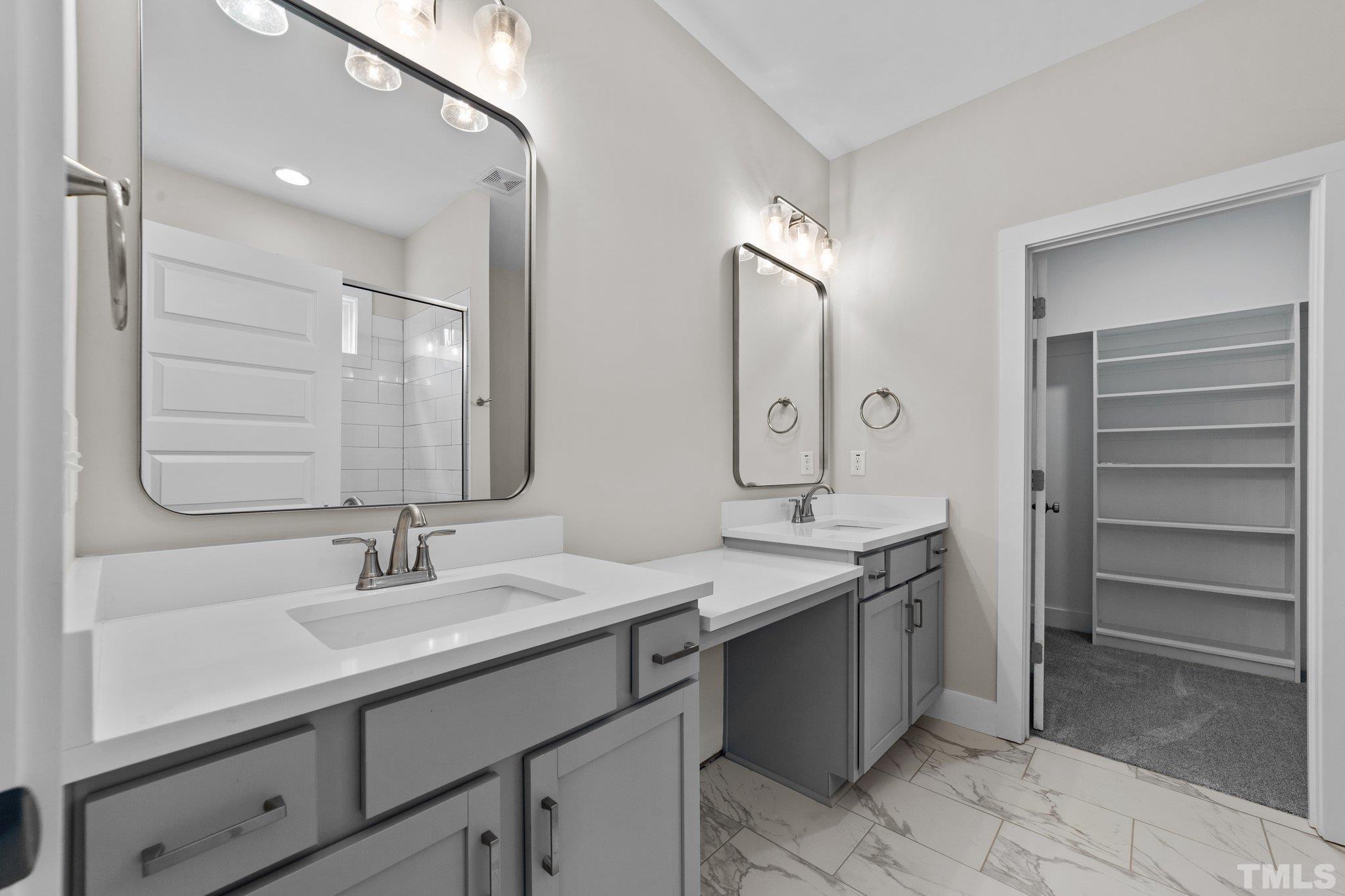 2748 Antioch Church Road Timberlake, NC 27583 - Photo 28 of 45 a bathroom with a sink double vanity and a mirror