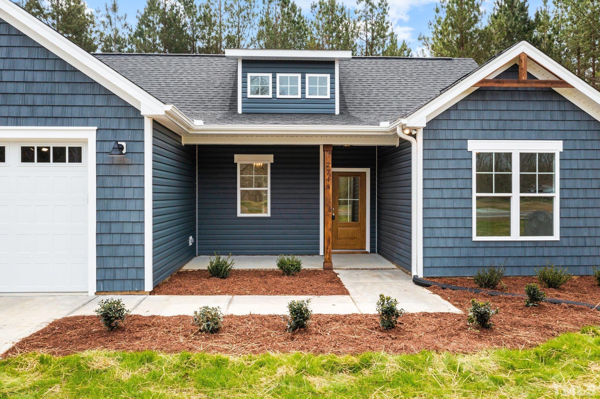 2748 Antioch Church Road Timberlake, NC 27583 - Photo 3 of 45 a view of a house with yard and sitting area