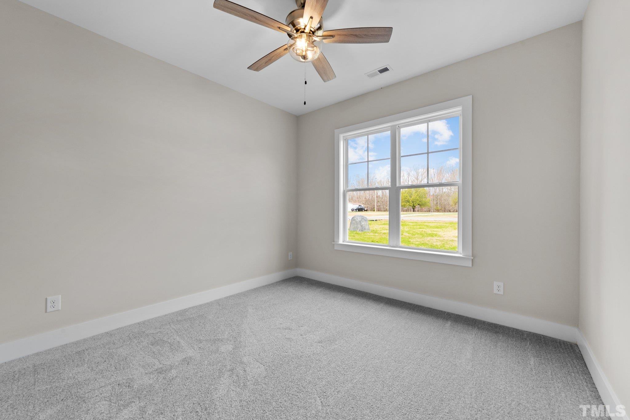 2748 Antioch Church Road Timberlake, NC 27583 - Photo 36 of 45 an empty room with a window and a ceiling fan