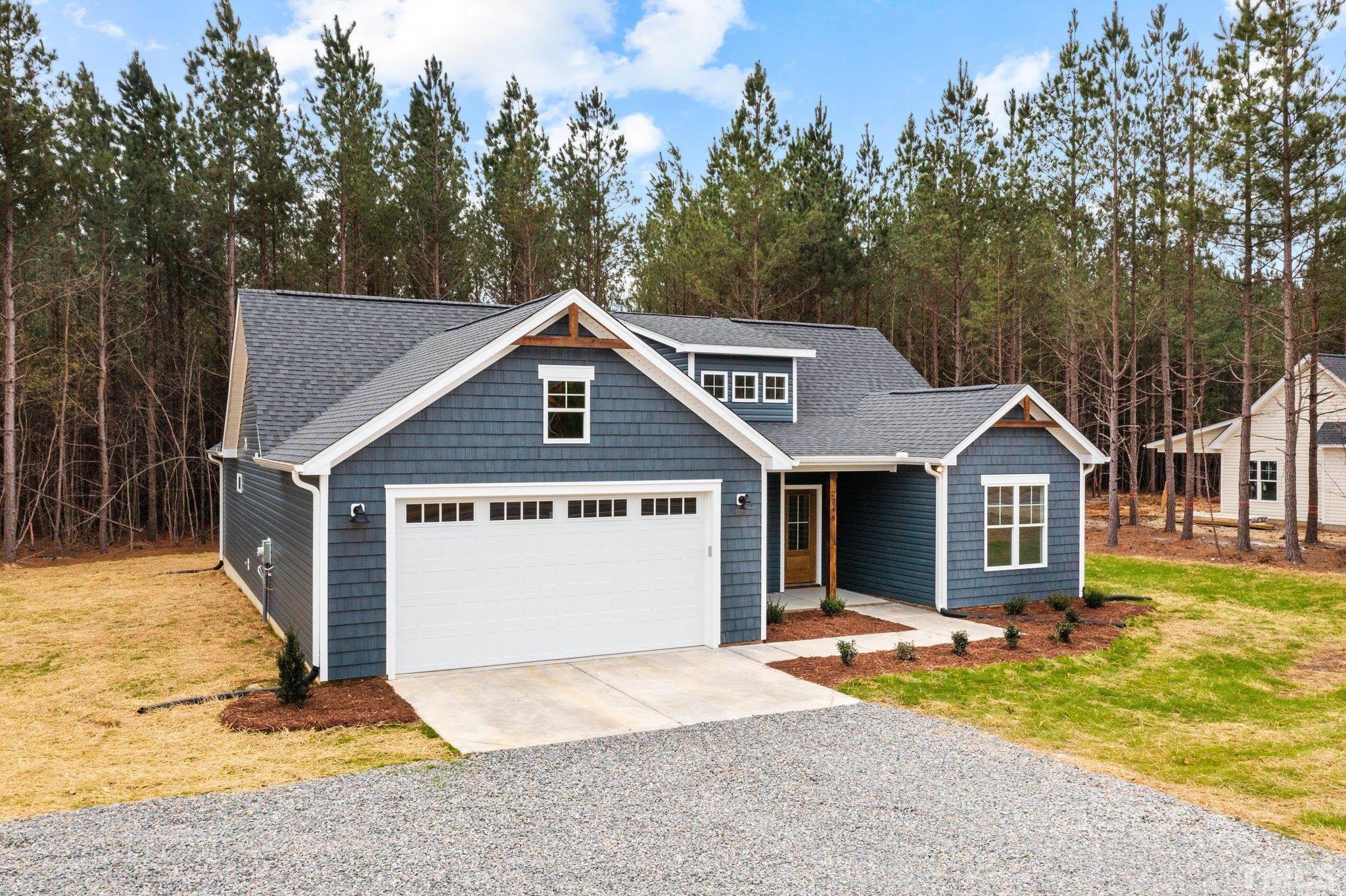 2748 Antioch Church Road Timberlake, NC 27583 - Photo 4 of 45 a view of a house with a yard and large tree