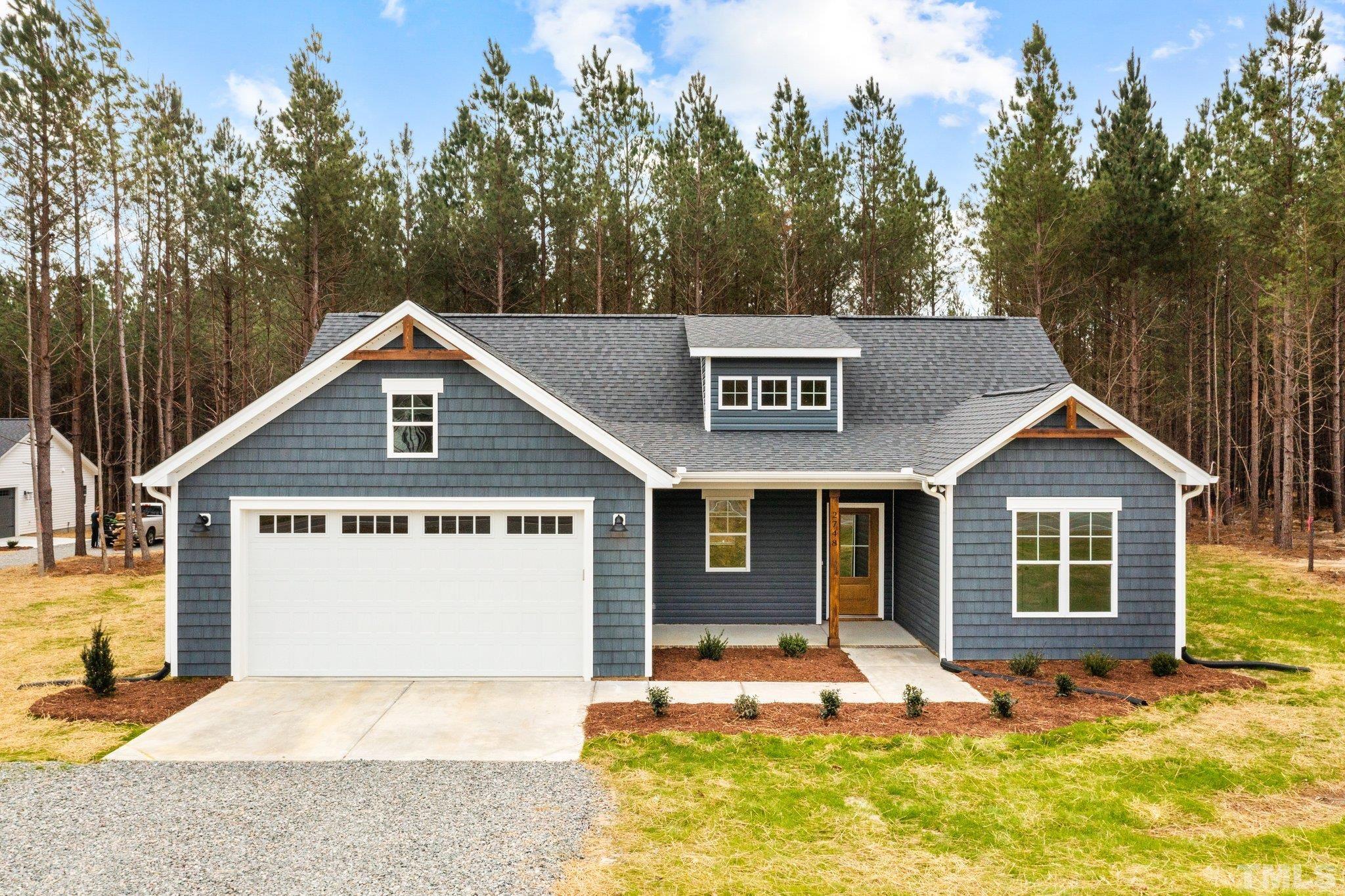 2748 Antioch Church Road Timberlake, NC 27583 - Photo 5 of 45 a front view of a house with garden