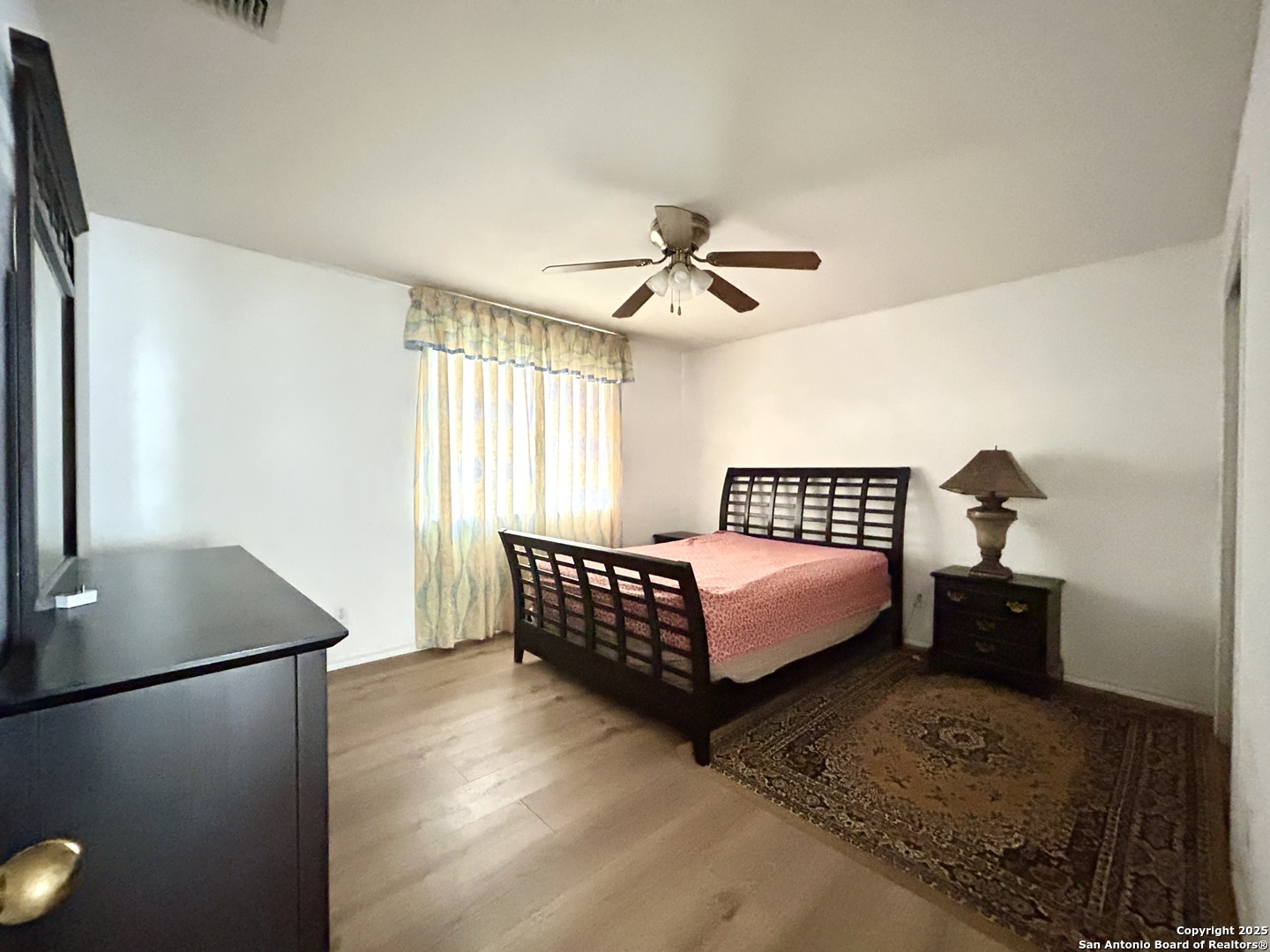 11023 Falling Water San Antonio, TX 78249 - Photo 19 of 30 a bedroom with a bed and window
