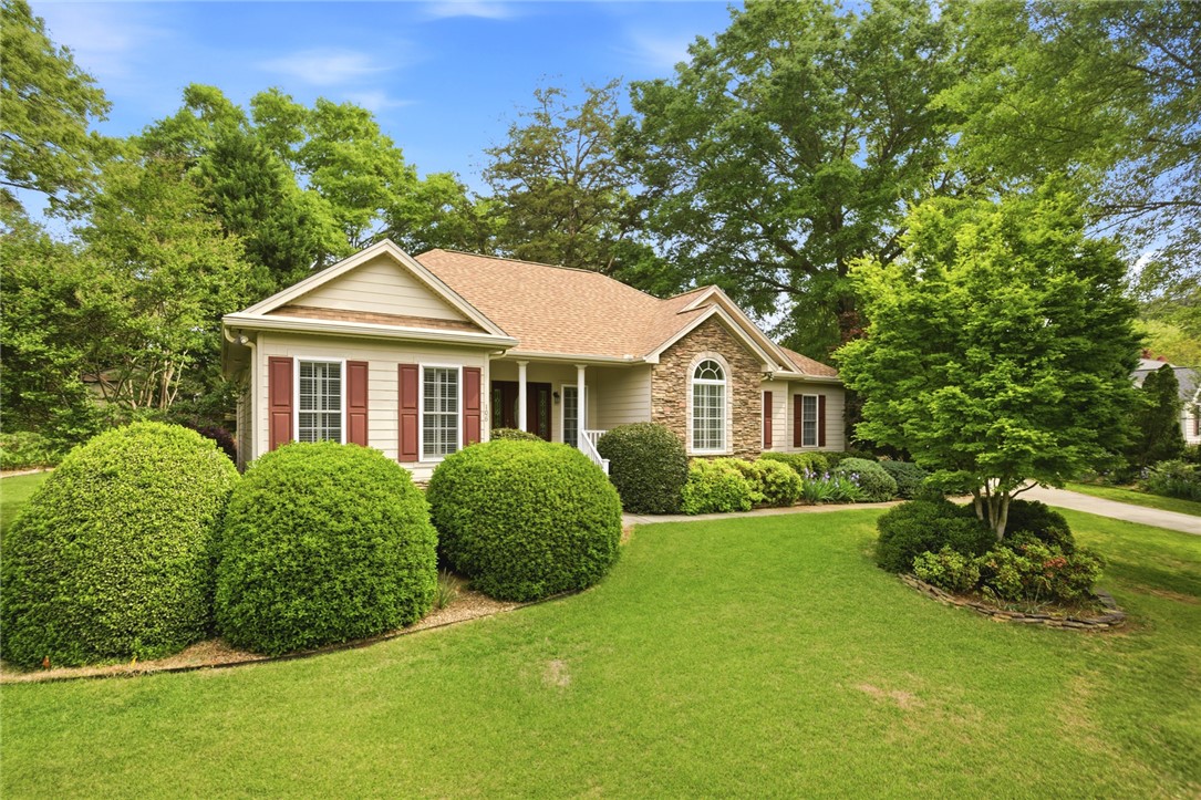 106 Cardinal Drive Seneca, SC 29672 - Photo 2 of 48 This charming home offers a welcoming facade with a well-maintained lawn and mature landscaping.