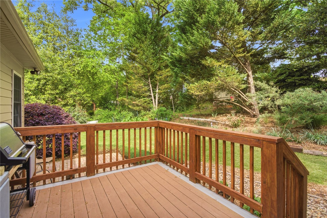 106 Cardinal Drive Seneca, SC 29672 - Photo 23 of 48 This outdoor deck provides a serene view of lush greenery, perfect for relaxation and entertaining.