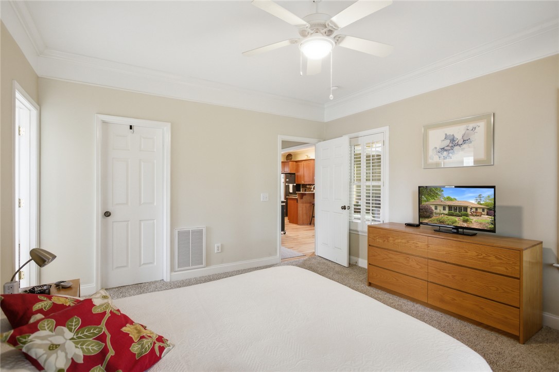 106 Cardinal Drive Seneca, SC 29672 - Photo 27 of 48 This cozy bedroom features a ceiling fan, crown molding, and plush carpet flooring for ultimate comfort.
