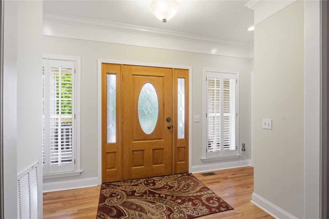 106 Cardinal Drive Seneca, SC 29672 - Photo 3 of 48 This entry welcomes all with warm wood flooring and elegant crown molding.