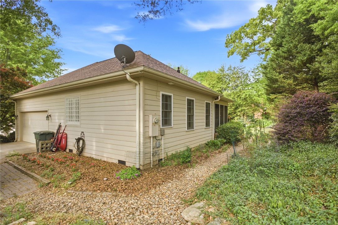 106 Cardinal Drive Seneca, SC 29672 - Photo 38 of 48 This charming home offers a serene escape with its inviting screened porch and lush surrounding foliage.