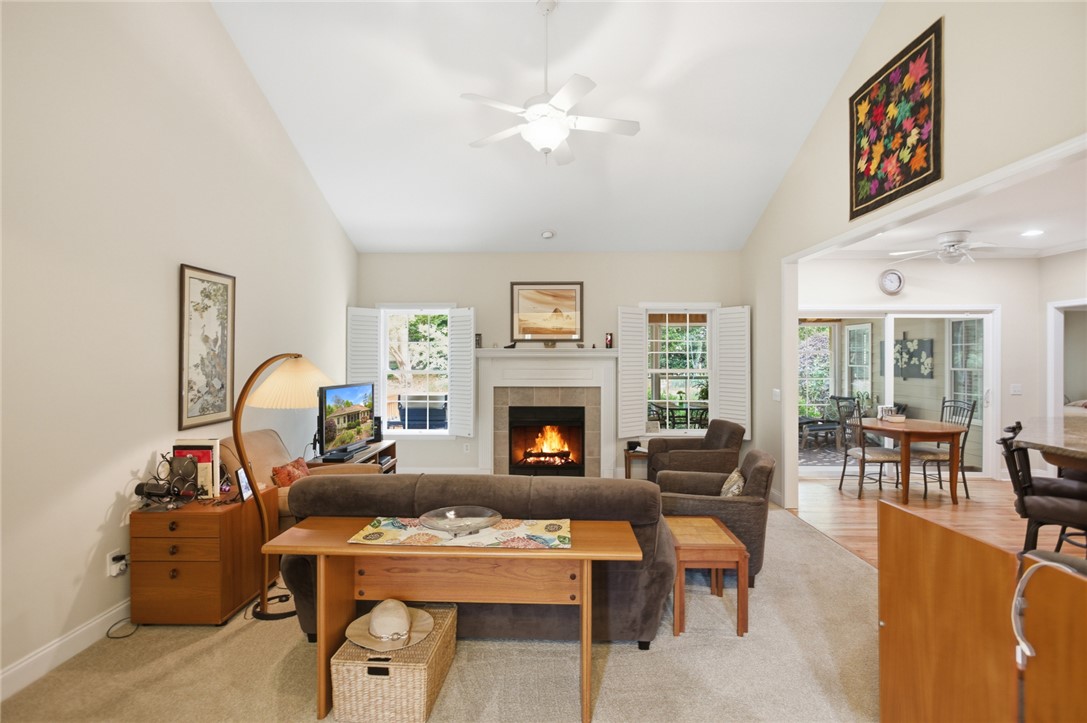 106 Cardinal Drive Seneca, SC 29672 - Photo 4 of 48 This inviting living area features high vaulted ceilings and a cozy fireplace, creating an airy and warm ambiance.