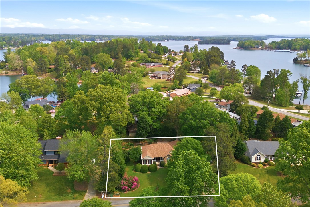 106 Cardinal Drive Seneca, SC 29672 - Photo 43 of 48 This tranquil waterfront property features lush green landscaping and offers serene lake views.