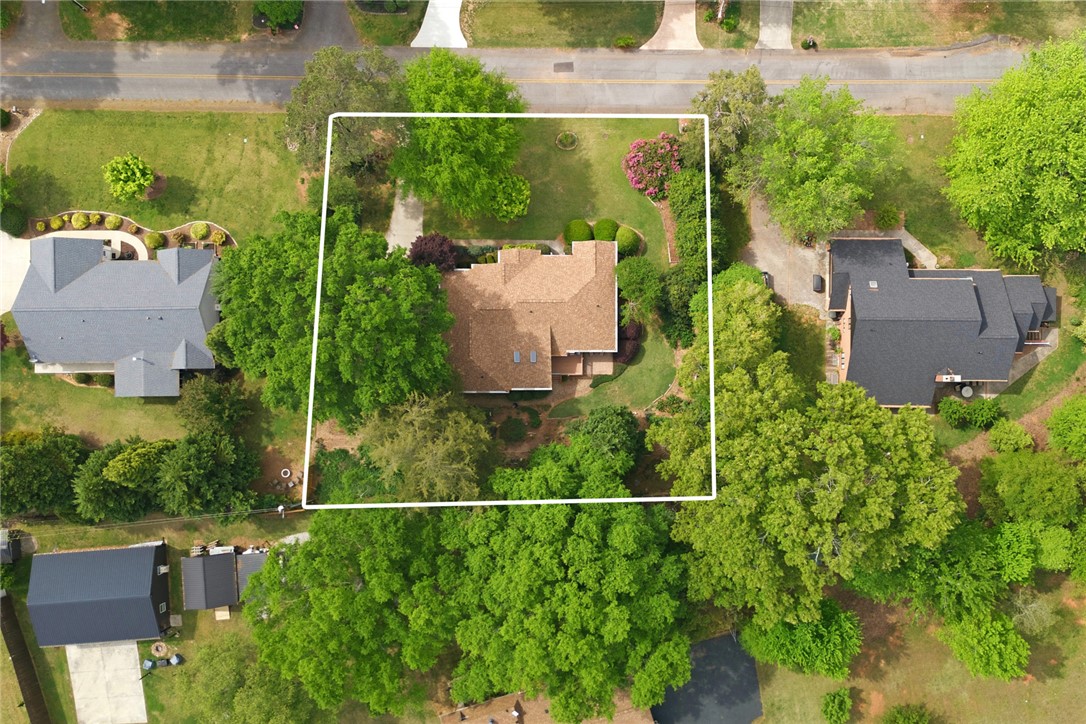 106 Cardinal Drive Seneca, SC 29672 - Photo 48 of 48 This verdant aerial view reveals a spacious property surrounded by lush trees and manicured grounds.