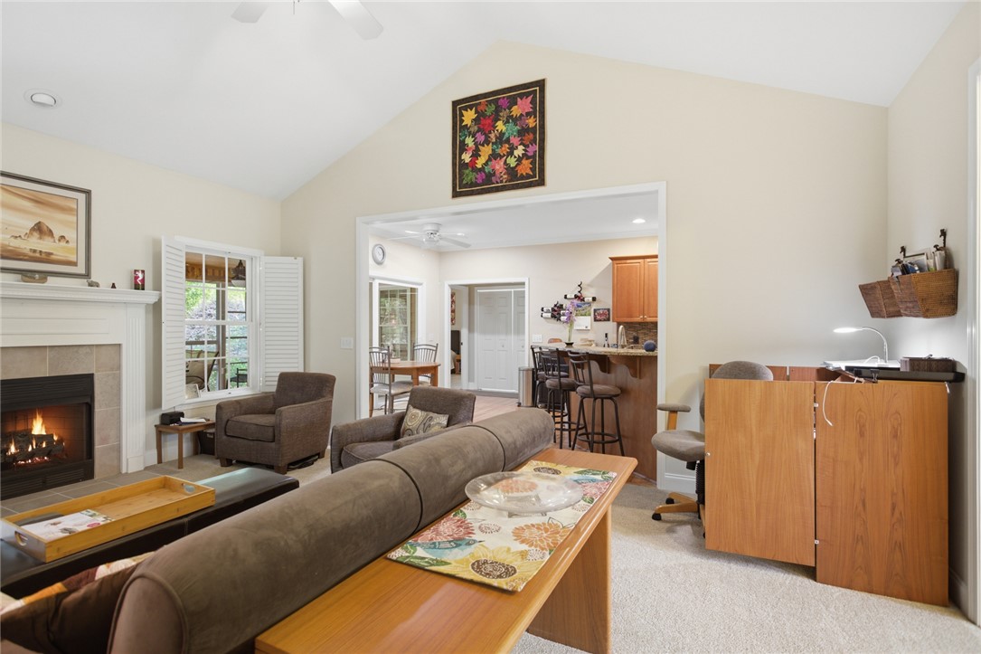 106 Cardinal Drive Seneca, SC 29672 - Photo 5 of 48 This inviting space features a vaulted ceiling, a cozy fireplace, and an open layout to the kitchen.