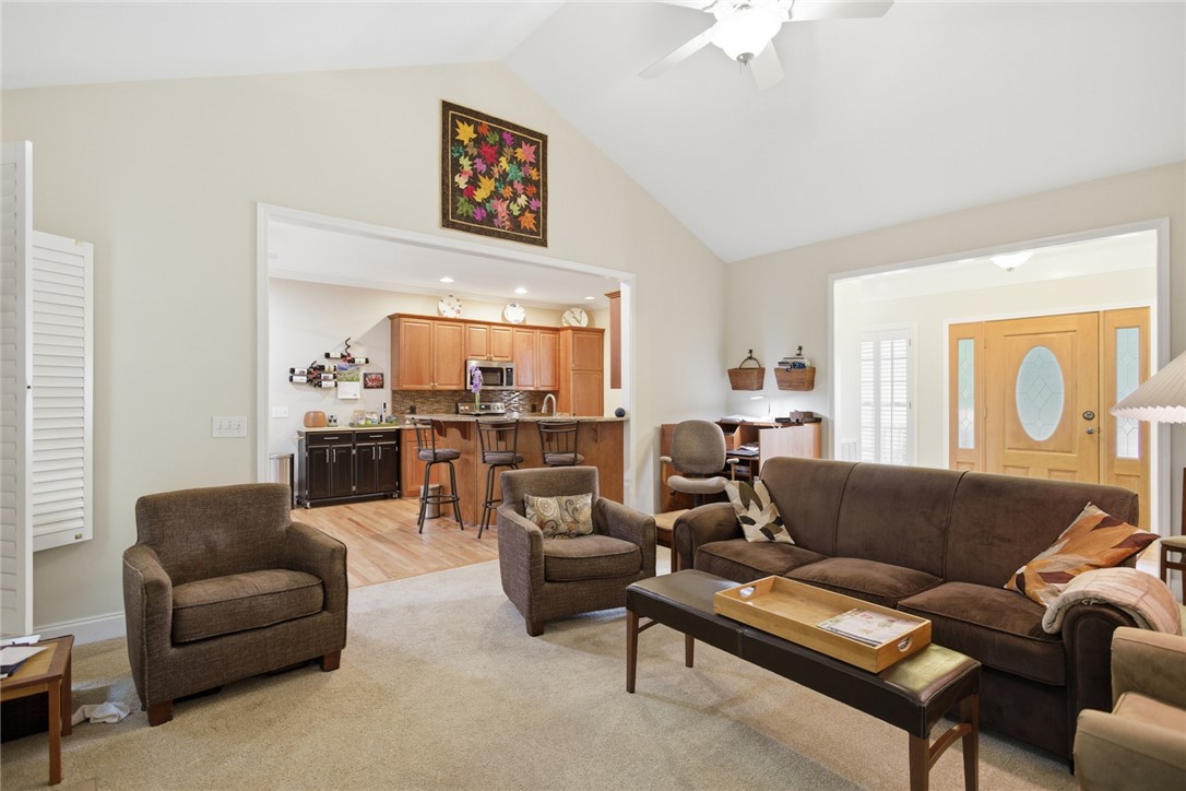106 Cardinal Drive Seneca, SC 29672 - Photo 7 of 48 Bright and airy living room with vaulted ceilings seamlessly connects to a functional kitchen.