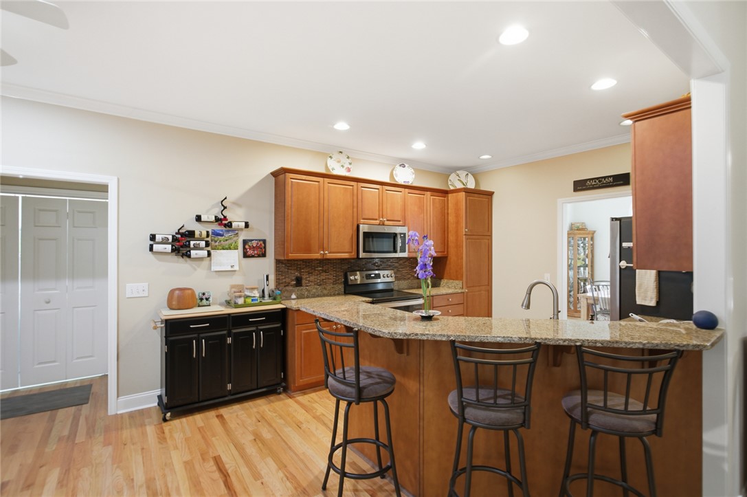 106 Cardinal Drive Seneca, SC 29672 - Photo 8 of 48 This kitchen features hardwood floors, granite countertops, and modern appliances, perfect for everyday living.