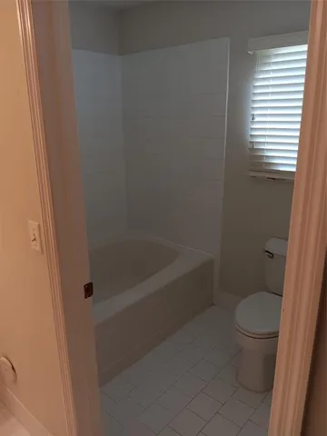 a bath room with a toilet and a shower