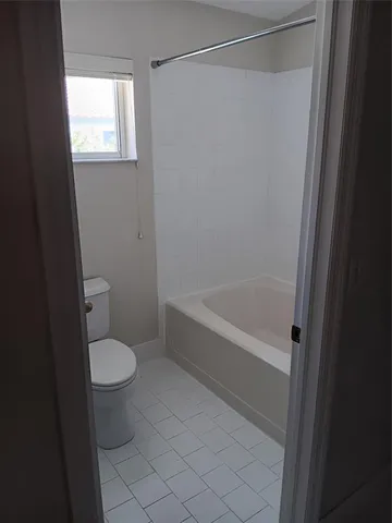 a bathroom with a toilet and a bathtub