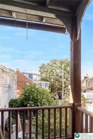 a bedroom with furniture and wooden floor