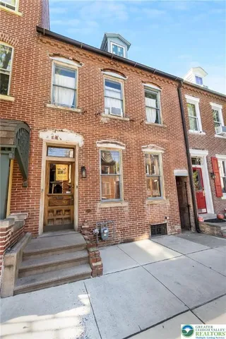 a view of a brick building with many windows