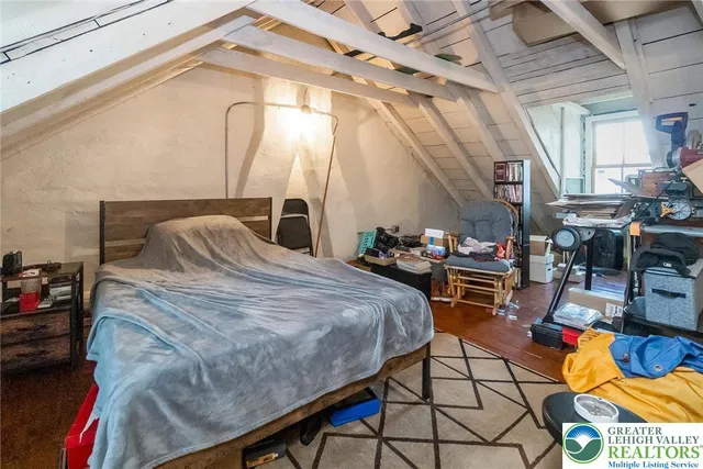 a bed sitting in a bedroom next to a window