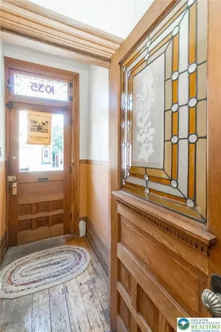 a living room with furniture a flat screen tv and a large window