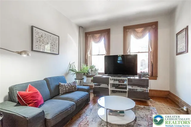 a view of a livingroom with furniture and a flat screen tv