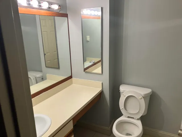 a bathroom with a toilet sink and shower