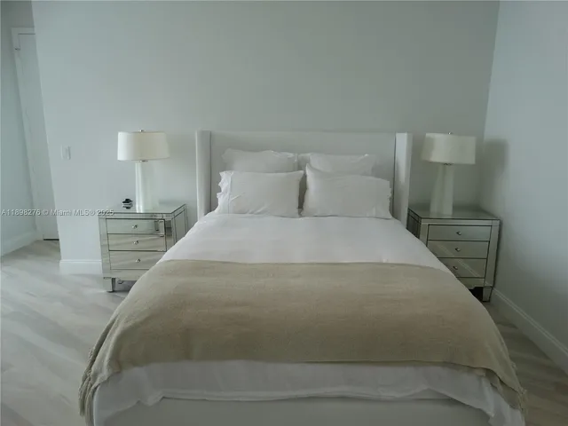 a large white bed in a white room