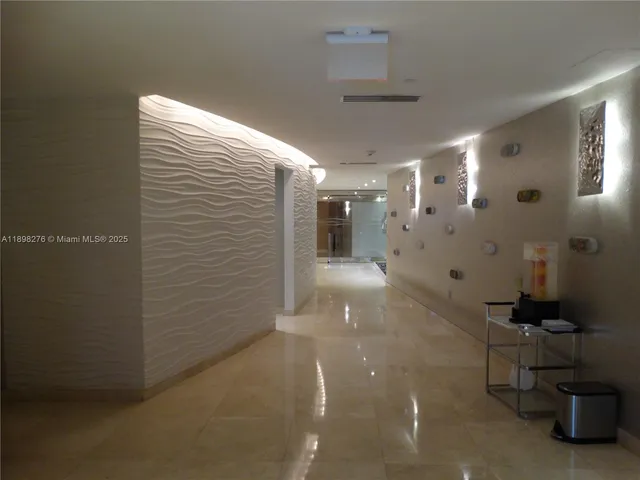 a view of staircase with white walls and a window