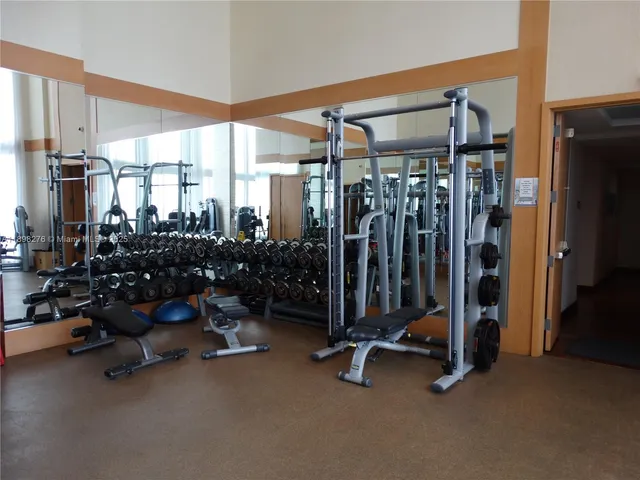 a front view of a room with balcony and furniture