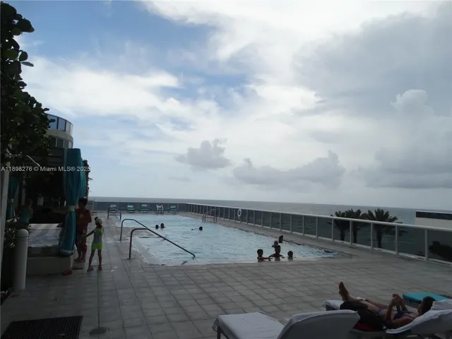 a view of a lake with a building and outdoor space