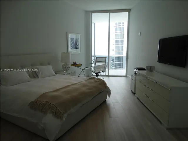 a bedroom with bed and window