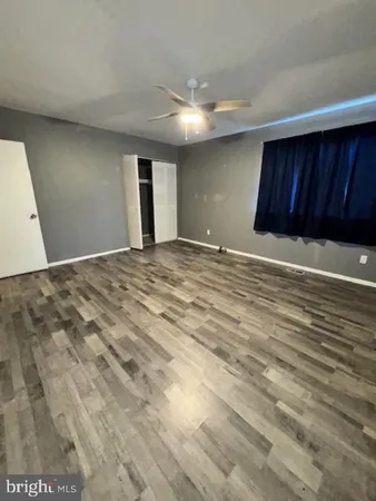 a view of an empty room and wooden floor