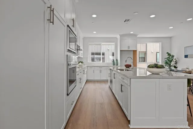 a kitchen with stainless steel appliances a sink and cabinets