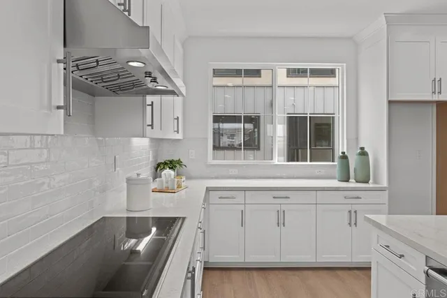 a kitchen with cabinets and window