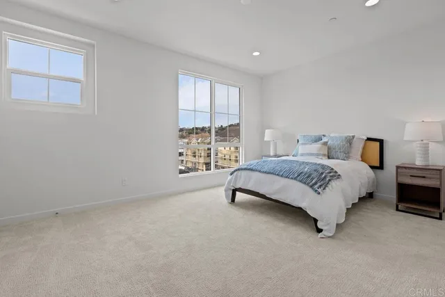 a bedroom with a bed lamp and window
