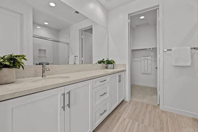 a bathroom with a double vanity sink and mirror