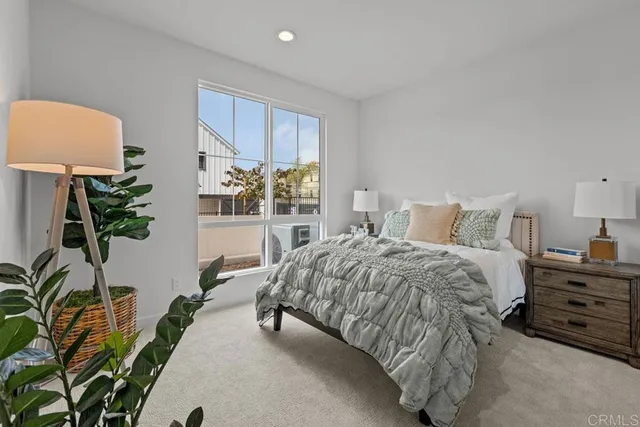 a bedroom with a bed and a potted plant