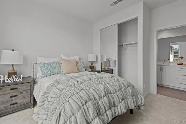 a bedroom with a bed and a lamp