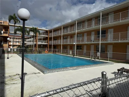 a view of a swimming pool with an outdoor seating